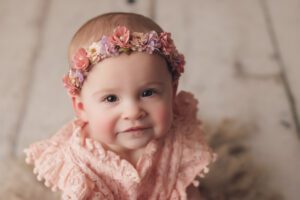Baby girl wearing a floral headband photographed during a Baltimore baby photography studio session