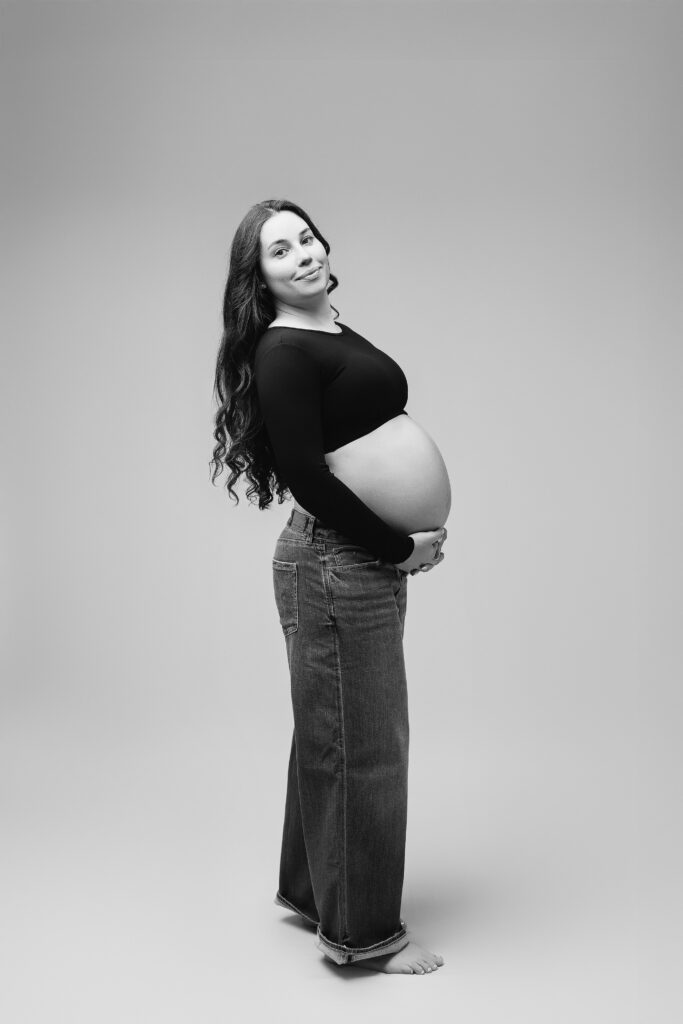 Black and white studio maternity portrait of a pregnant woman taken in a Maryland photography studio